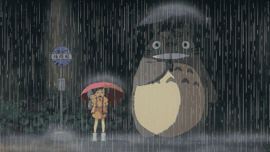 Satsuki standing next to the giant Totoro at the rainy bus stop, carrying Mei on her back.