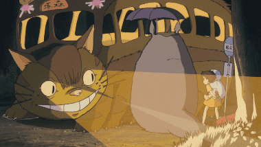 Totoro boarding the twelve-legged Catbus with its glowing destination sign.
