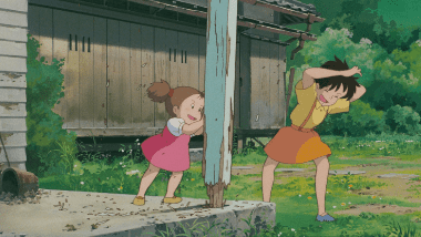 Satsuki and Mei playing excitedly after arriving at the old house.