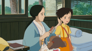 Satsuki looking entranced as her mother combs her hair in the hospital room, with a smiling Mei.