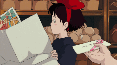 Kiki receiving a party invitation from Tombo at the bakery counter