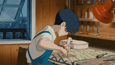 Seiji carving a violin in his workshop