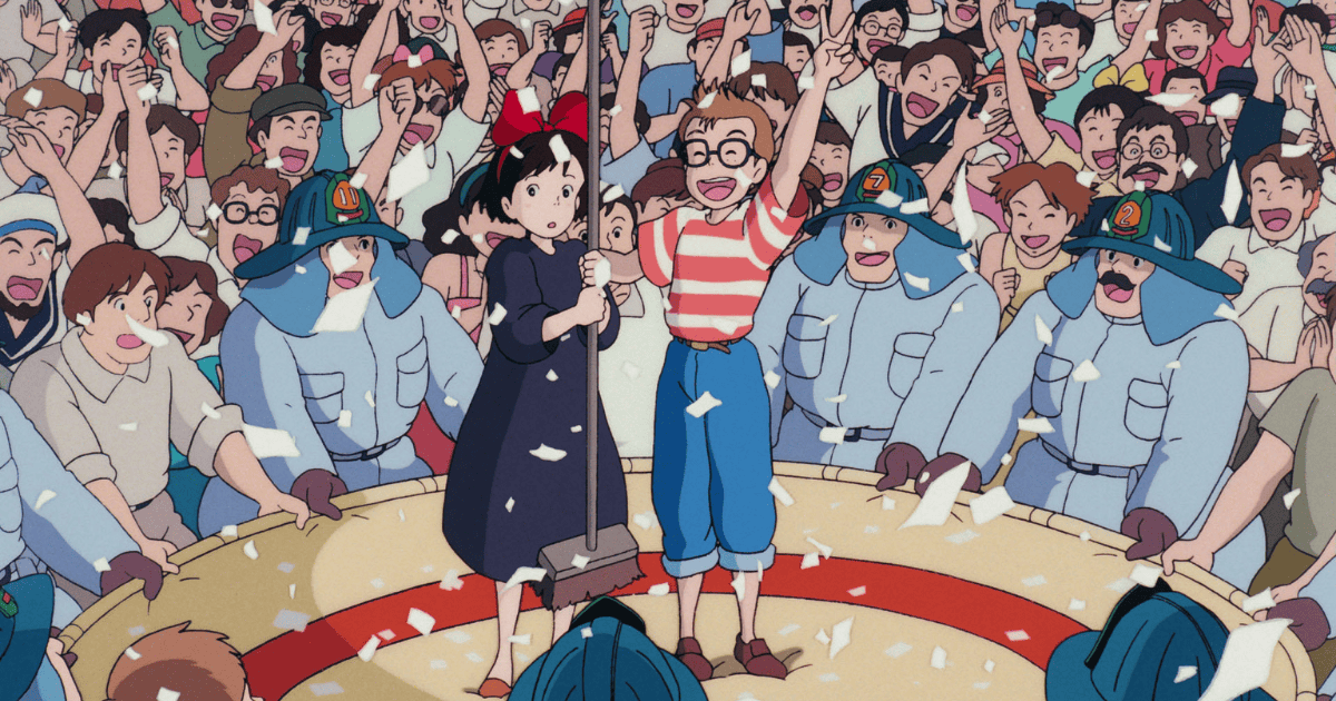 Young witch standing with a boy amid cheering crowds and firefighters after a dramatic rescue