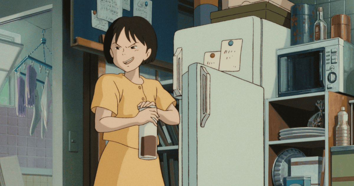 Young woman opening a drink bottle beside a refrigerator in a small Japanese kitchen