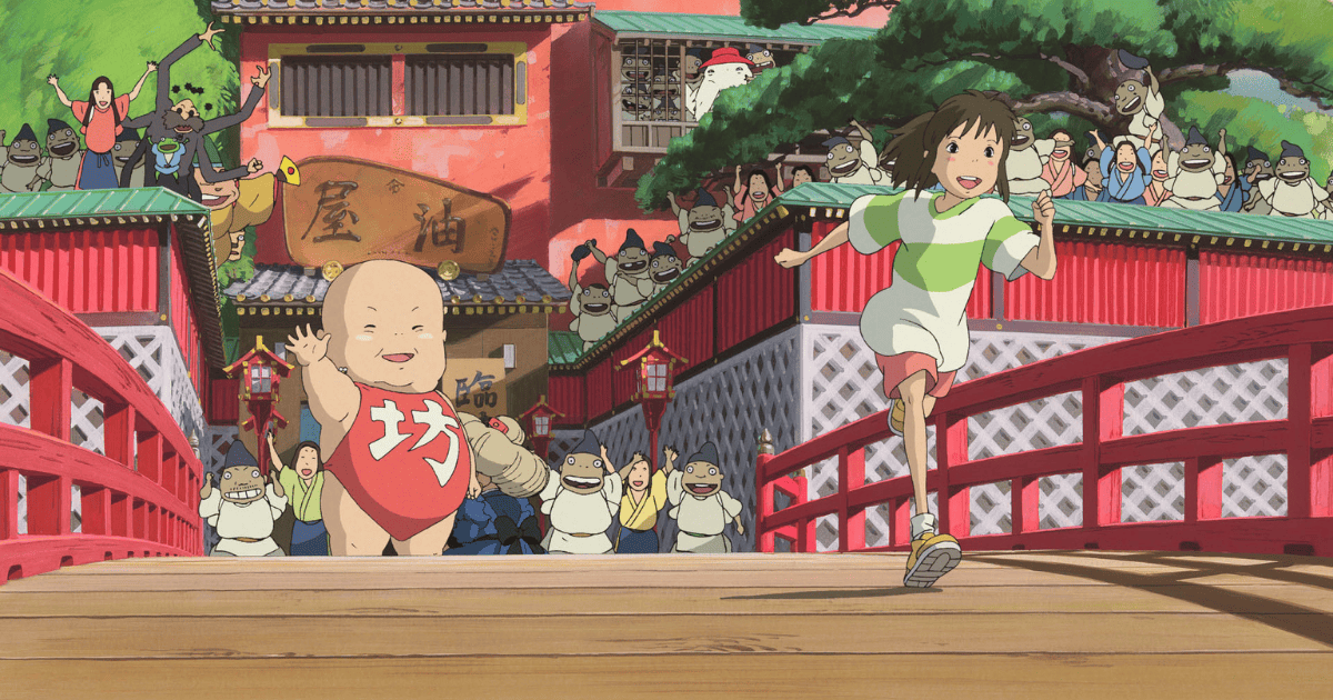 Chihiro running across the red bridge with Boh as bathhouse workers cheer in Spirited Away