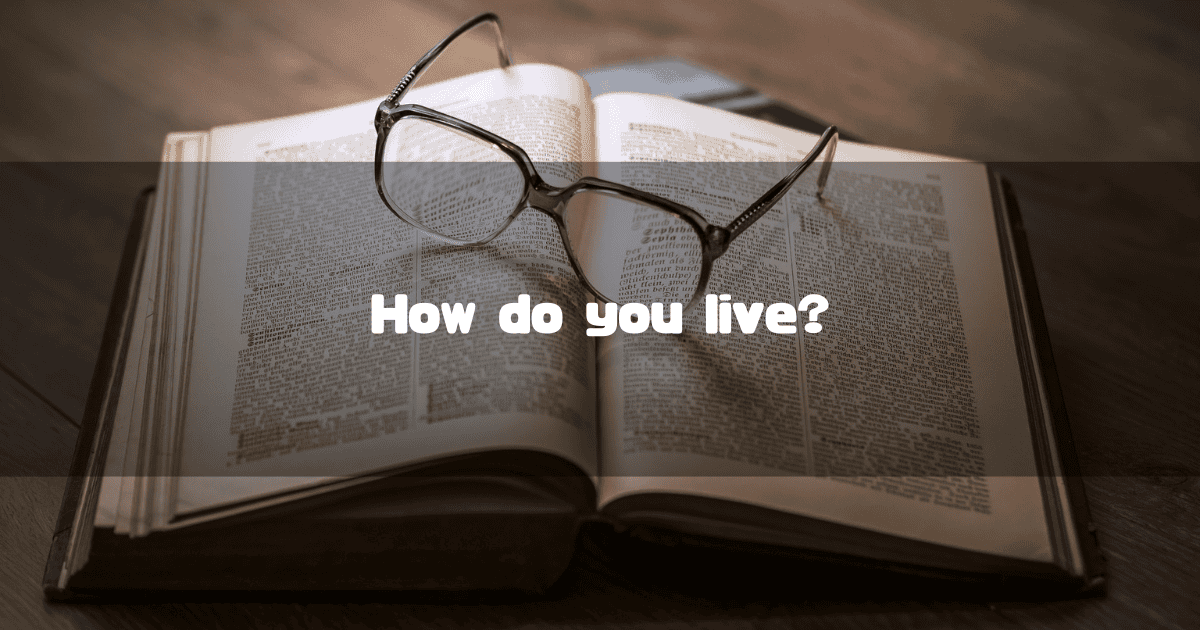A close-up of an open, old book with reading glasses resting on its pages, featuring the text "How do you live?"