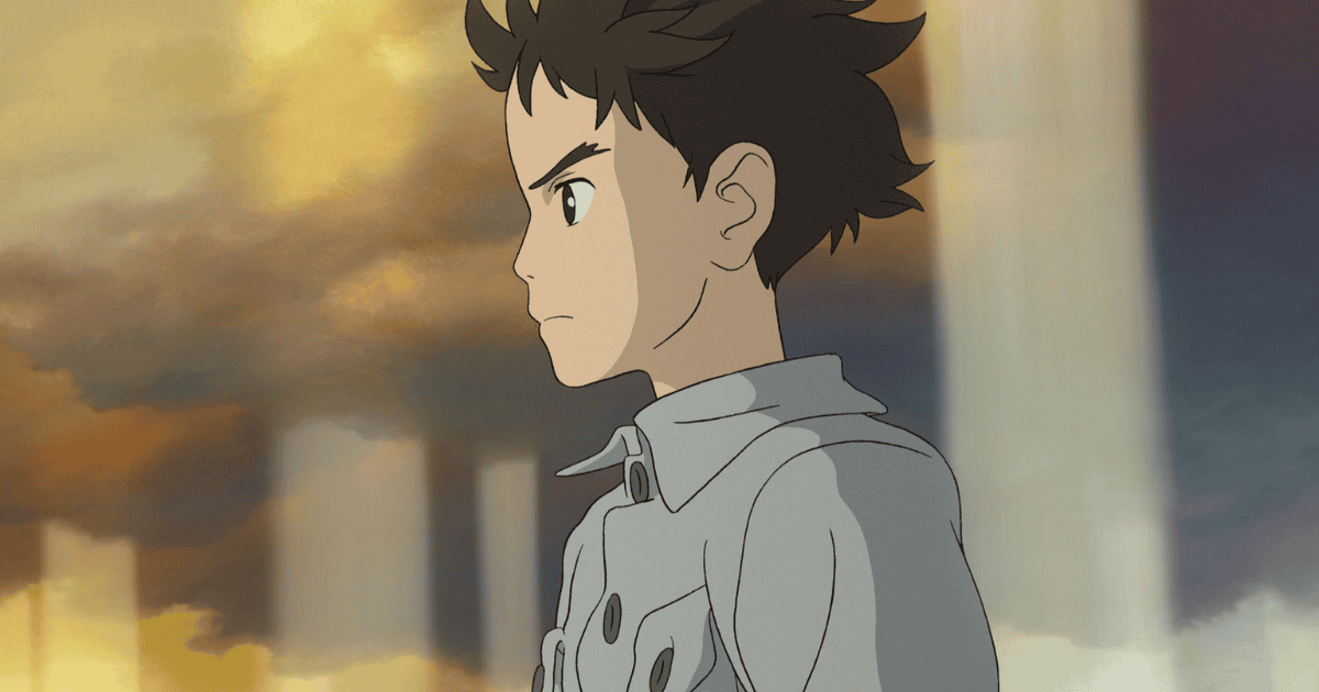 Mahito Maki standing beneath a surreal golden sky and towering stone pillars in The Boy and the Heron