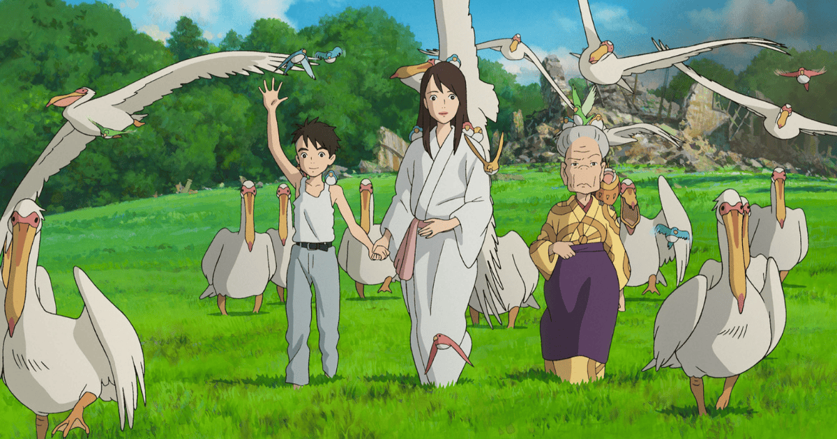 Mahito standing with two women among a flock of pelicans in a lush green field in The Boy and the Heron
