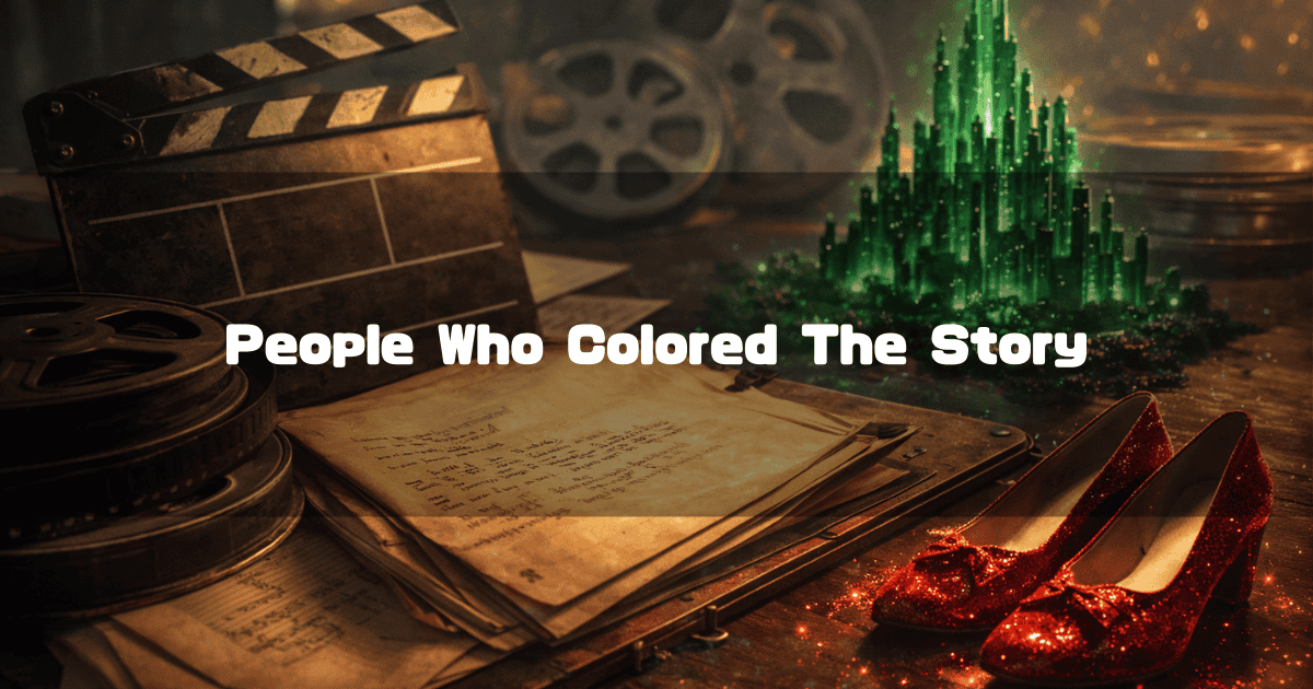 Movie clapperboard, film reels, handwritten script, sparkling ruby red slippers, and a miniature glowing Emerald City on a desk. Text reads: "People Who Colored The Story".